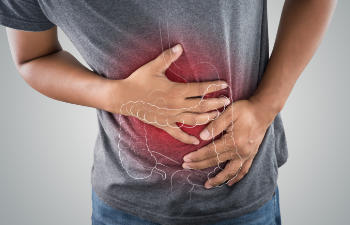 man holding his stomach in pain