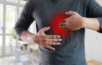 man holding his chest in pain