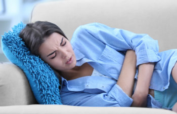 woman lying with stomach ache